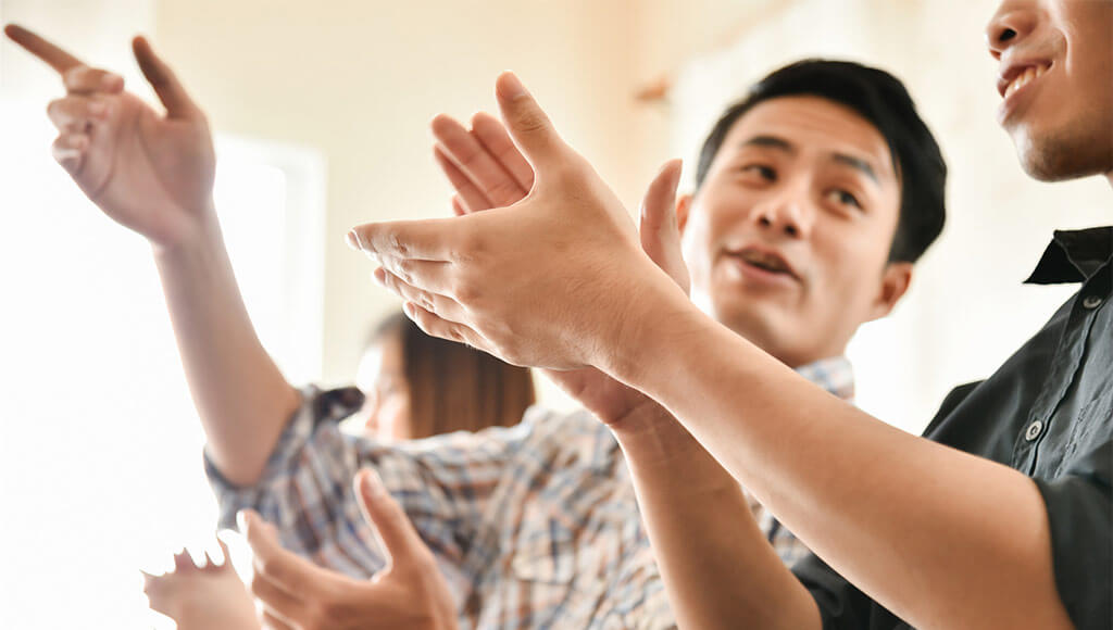 Business people clapping hands at conference.