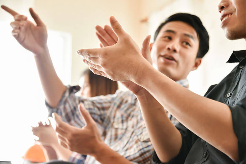 Business people clapping hands at conference.