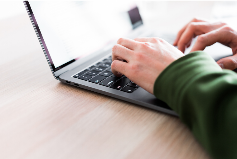 hands typing on a laptop