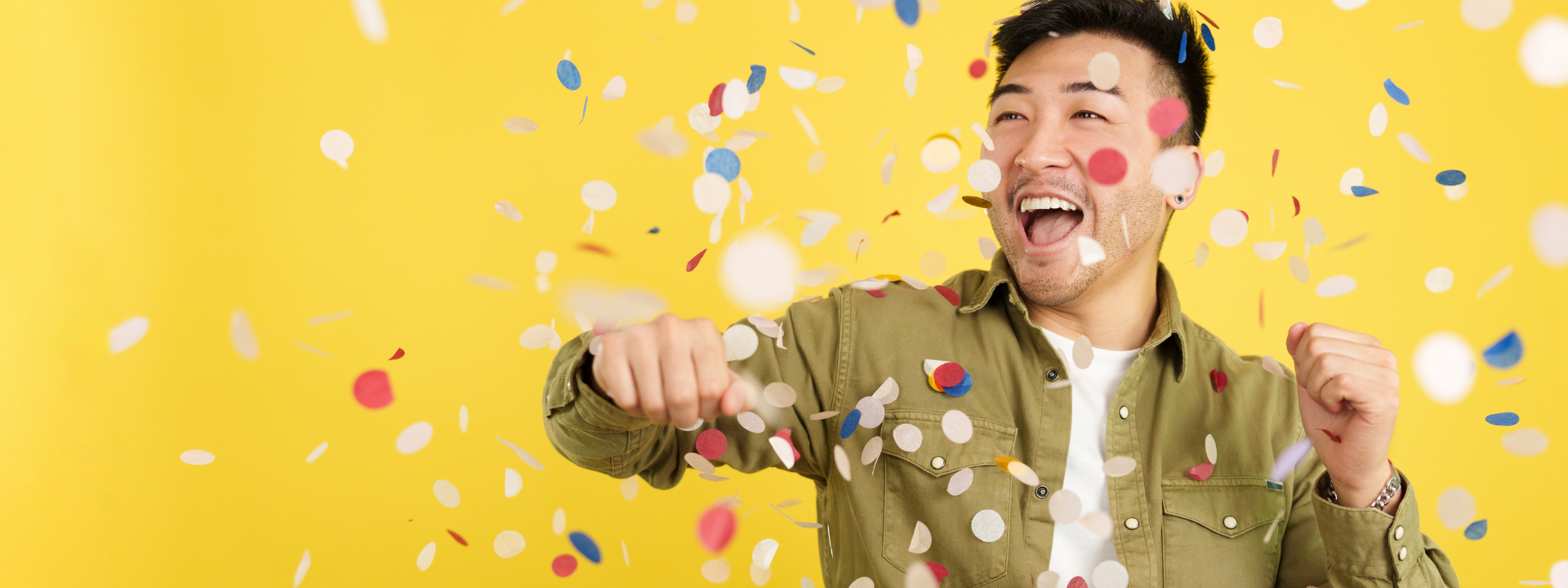 A man celebrates as confetti falls