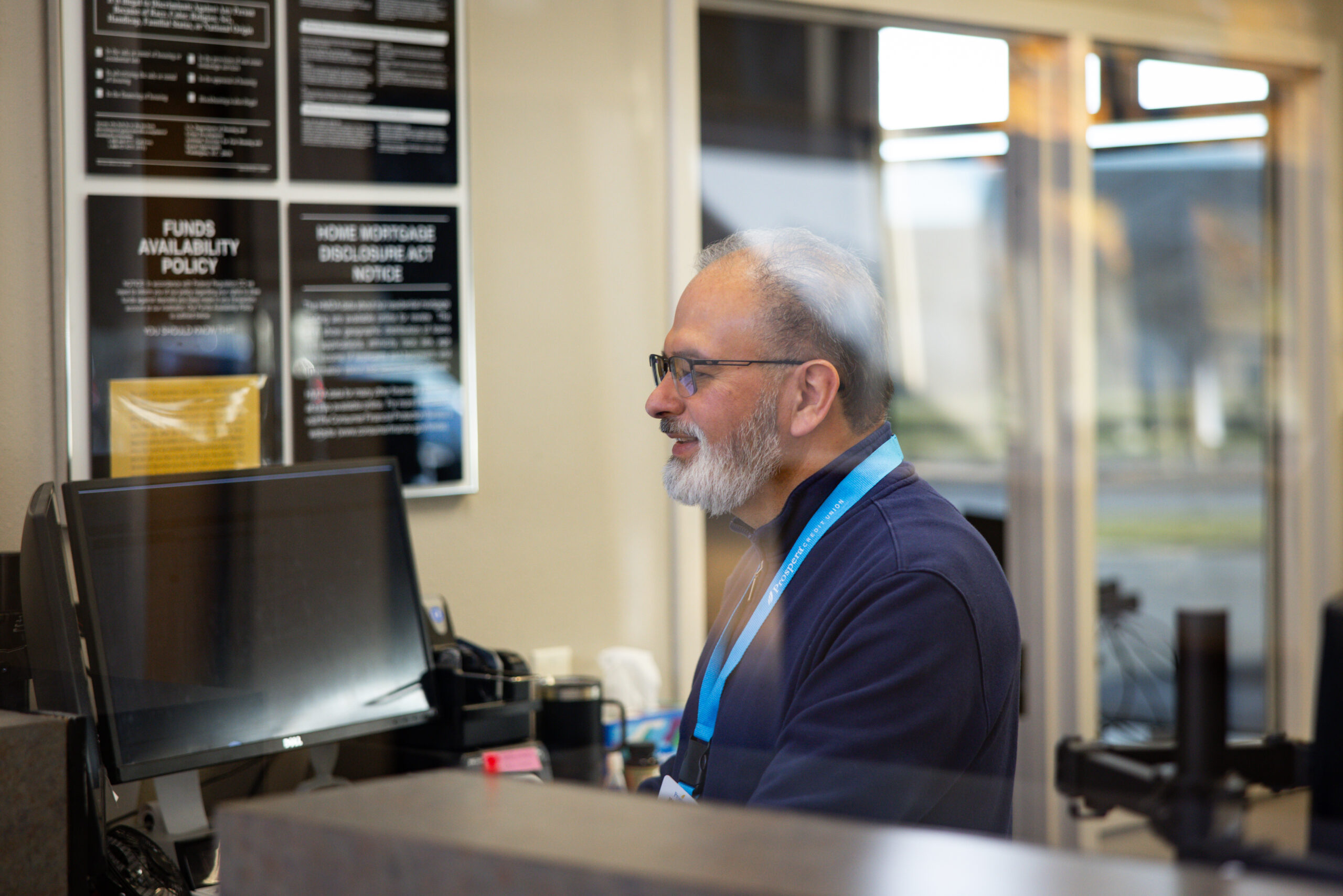 bank teller working at computer